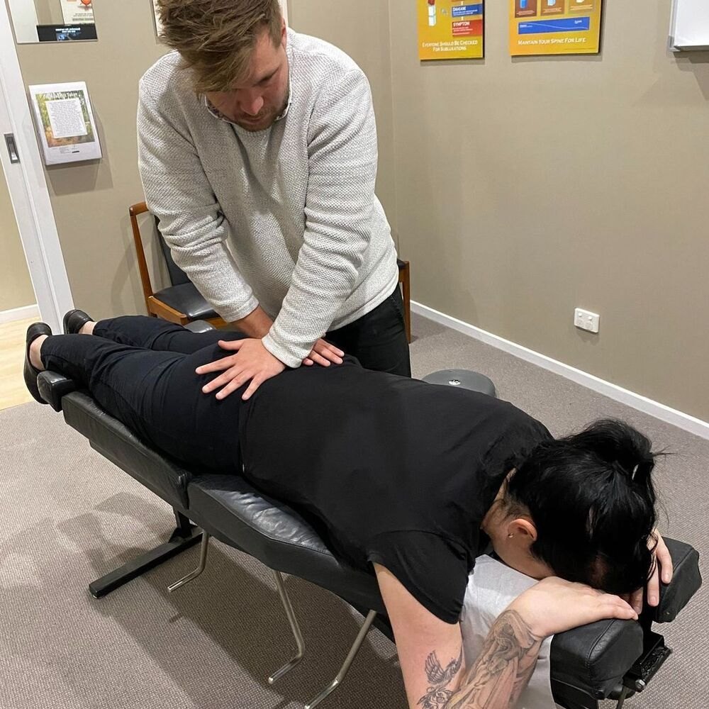 Dr Matt adjusting a patient's lower back on the drop table