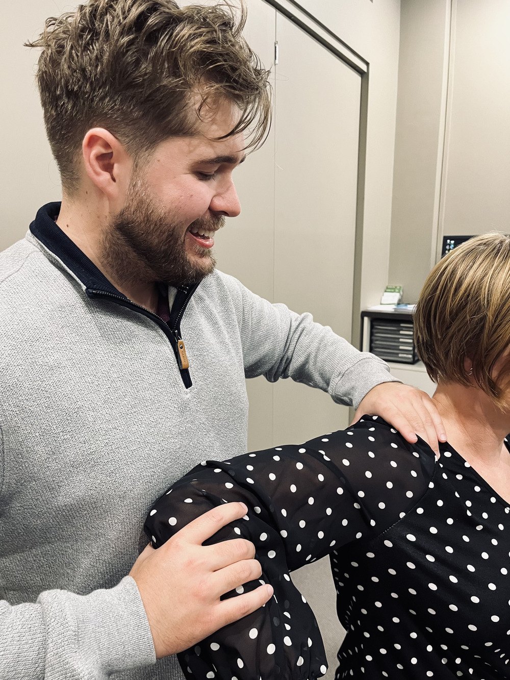 Dr Matt checking a patient's shoulder