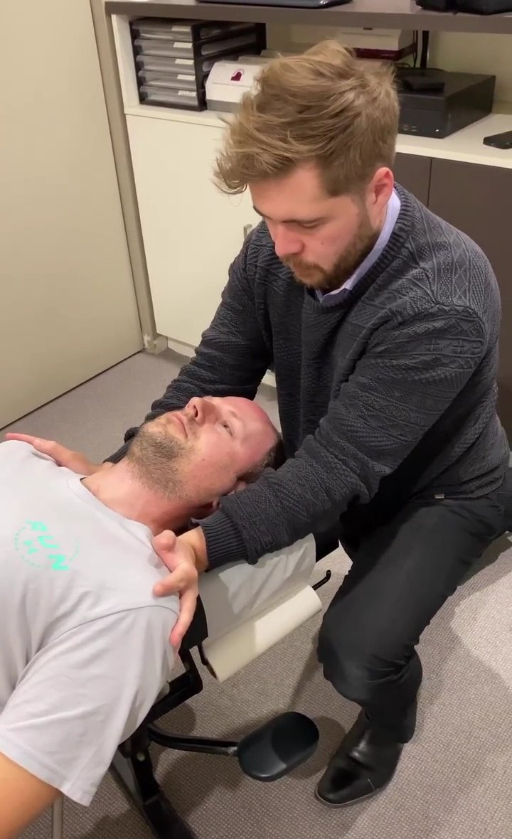 Dr Matt adjusting a patient's neck